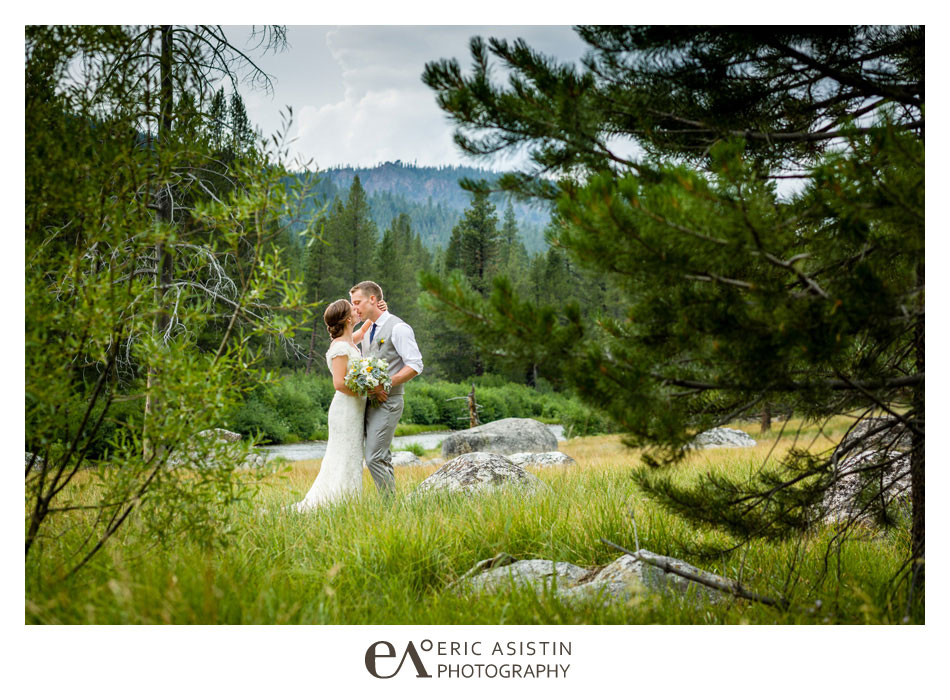Rustic Truckee River Wedding. Bride and Groom kiss in meadow alongside the Truckee River