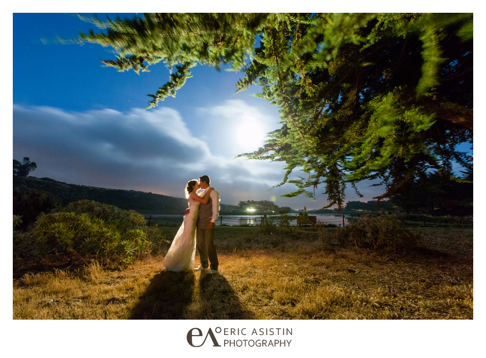 Bride & groom kiss under the moonlight at the Pajaro Dunes Lagoon Club House