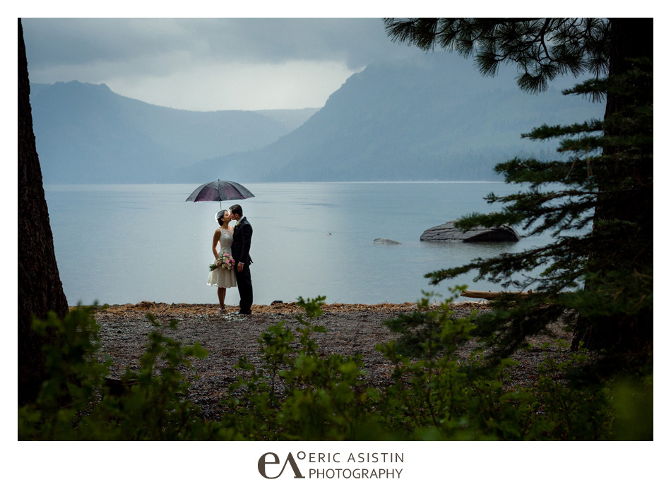 Bride and Groom kiss underneath an umbrella during their rainy day wedding elopement at Fallen Leaf Lake South Lake Tahoe.
